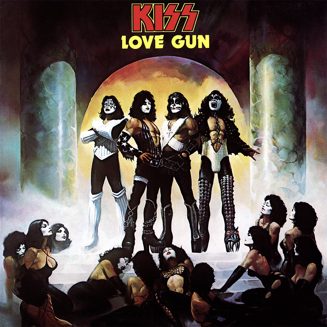 KISS stand at the top of the stairs in a stone temple with female KISS fans in facepaint at their feet.
